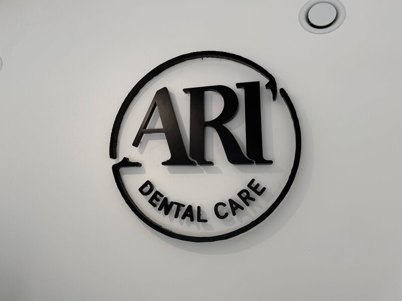 An image of the ARI Dental Care interior wall signage.